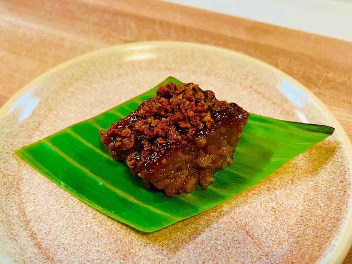 Slice of biko on a banana leaf lined plate